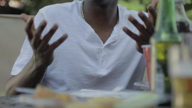 Man Using Hands to Talk at Barbecue