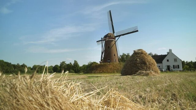 Typical Dutch Windmill with a traditional hay bale - Slider / Wide Shot -