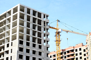 Fototapeta premium Crane and building construction site against blue sky