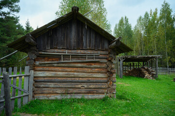 Ancient northern russian wooden cabins and churches in the wood near the river