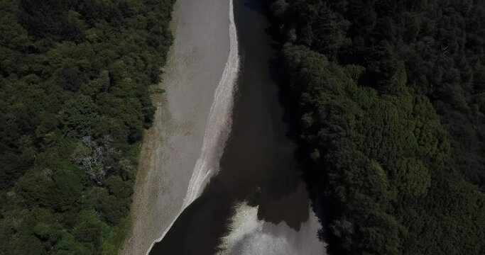 Flying down the Gualala River towards a forest