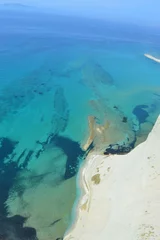 The beautiful turquoise ocean in the Ionian Sea surrounding the island of Corfu, Greece