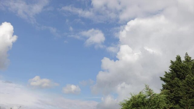 Single puffy white cloud in blue sky