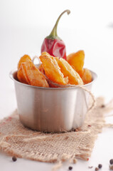 sandwich on a white background with chili french fries and with a gloved hand