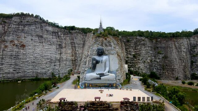 Suphan Buri / Thailand / August 15, 2020 : ( Rock Buddha ) Wat Khao Tham Thiam, buddha statue in the park.

