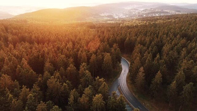 Drone flight over the forest and road during sunset, Taunus Hessen Germany
