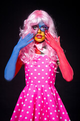 Girl in the suit and the image of a terrible dead doll with a sewn mouth. Halloween.