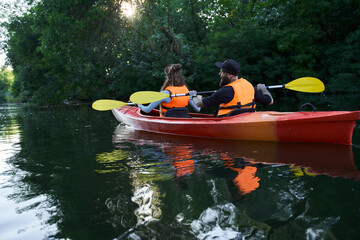 people on kayak outing rafting down the river