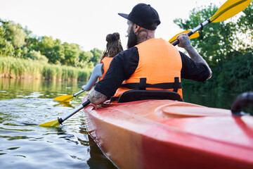 Loving couple kayaking on river