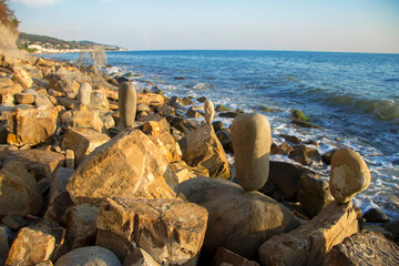 Balanced stones on the seashore summertime and sea background