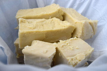 Freshly handmade natural soap put to dry in a bucket covered with fabrics