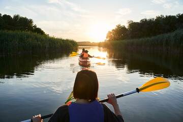 Group of happy tourists walking on kayaks