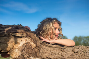 verträumte  junge Frau  am Baum