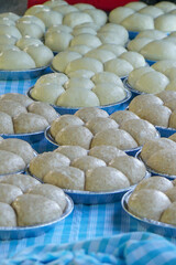 Rising bread rolls on blue tablecloth