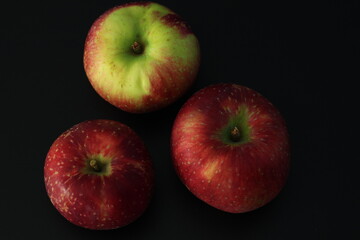 Polish red and yellow apples on a black background