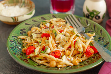 
Rustic homemade italian pasta with roasted vegetables and parmesan cheese
