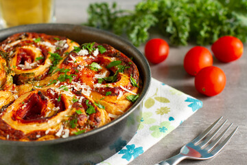 Savory tomato and cheese puff pastry rolls on a tray