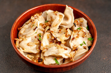 Dumplings stuffed with stewed cabbage on a stone background