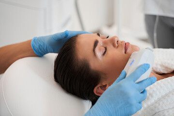 Obraz na płótnie Canvas Woman face receiving ultrasound procedure