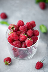 ripe large raspberries in a glass bowl