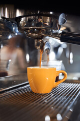 Yellow cup standing on the grating