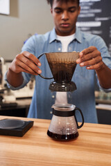 Barista hands putting ceramic dripper