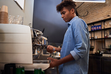 Barista brewing coffee using coffee machine