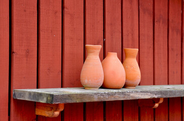 Fototapeta na wymiar Pottery vases on shelf.