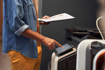 Man making copies and working with printer