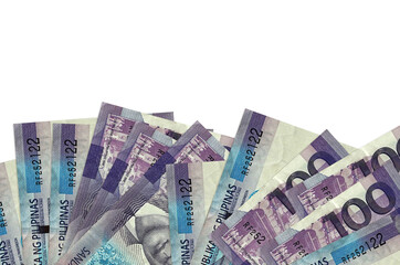 100 Philippine piso bills lies on bottom side of screen isolated on white background with copy...