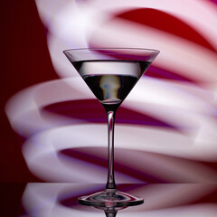 Martini glass on a red background with white lights.