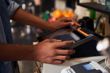 Barista at the cash counter confirming order