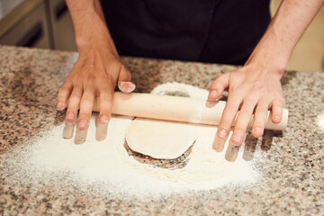 Close up shot of pizzaiolo making dough for Pizza