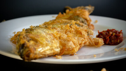 Bandeng Presto Goreng. Fried tendered-bone milkfish served with traditional side dishes
