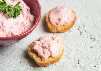 Crostini or bruschetta with tarama or taramasalata canape and a bowl close-up on the gray background