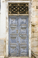 old door with peeling paint in Ermoupoli, Syros island Greece