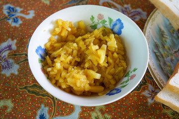Homemade pineapple jam in a bowl on tablecloth