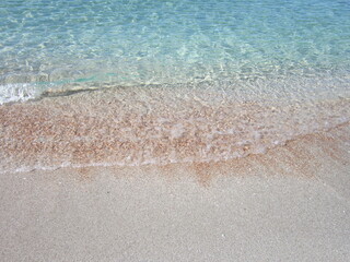 Fototapeta na wymiar Sand beach. Transparent water, small waves. II