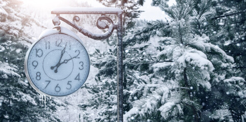Street clock in winter.  Change to winter time