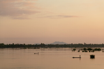Muong Khong Laos 1/12/2012 Mekong river at dawn with golden sun and fishing boat
