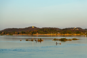 Muong Khong Laos 1/12/2012 Mekong river at sunset with and fishing boat and nets