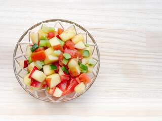Homemade colorful tasty healthy salad with tomatoes , apple and cucumber