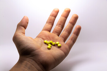 Man offers yellow pills as medicine photo