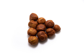 Beautiful hazelnuts collected in a shape on a white isolated background macro photo