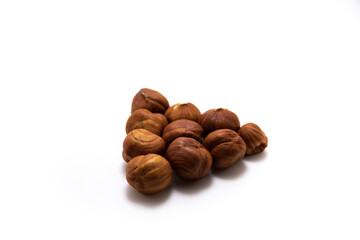 Beautiful hazelnuts collected in a shape on a white isolated background macro photo