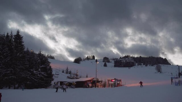 Passing clouds in Donovaly, Slovenia with skiers