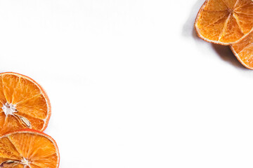 Dried oranges peeking from corners. Autumn / winter theme background. Double side border from top view, empty space for text.