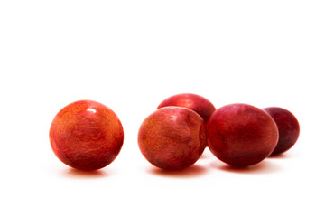 Several red grapes on white isolated background