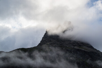peak of a mountain in the clouds