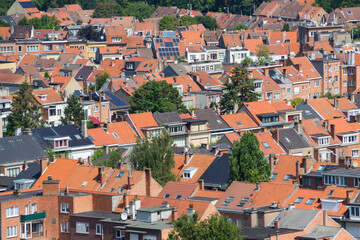 Fototapeta na wymiar Red rooftops of residential buildings seen from above in a big city